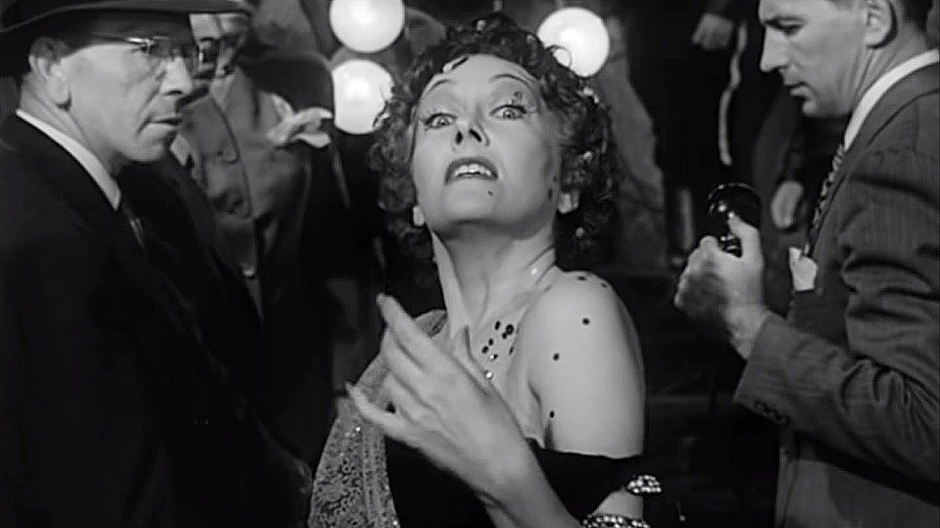 Norma Desmond (Gloria Swanson) walking down the stairs surrounded by police and reporters in 'Sunset Boulevard,' The Dark Side of Cinema: Uncover the Masterpieces of Film Noir