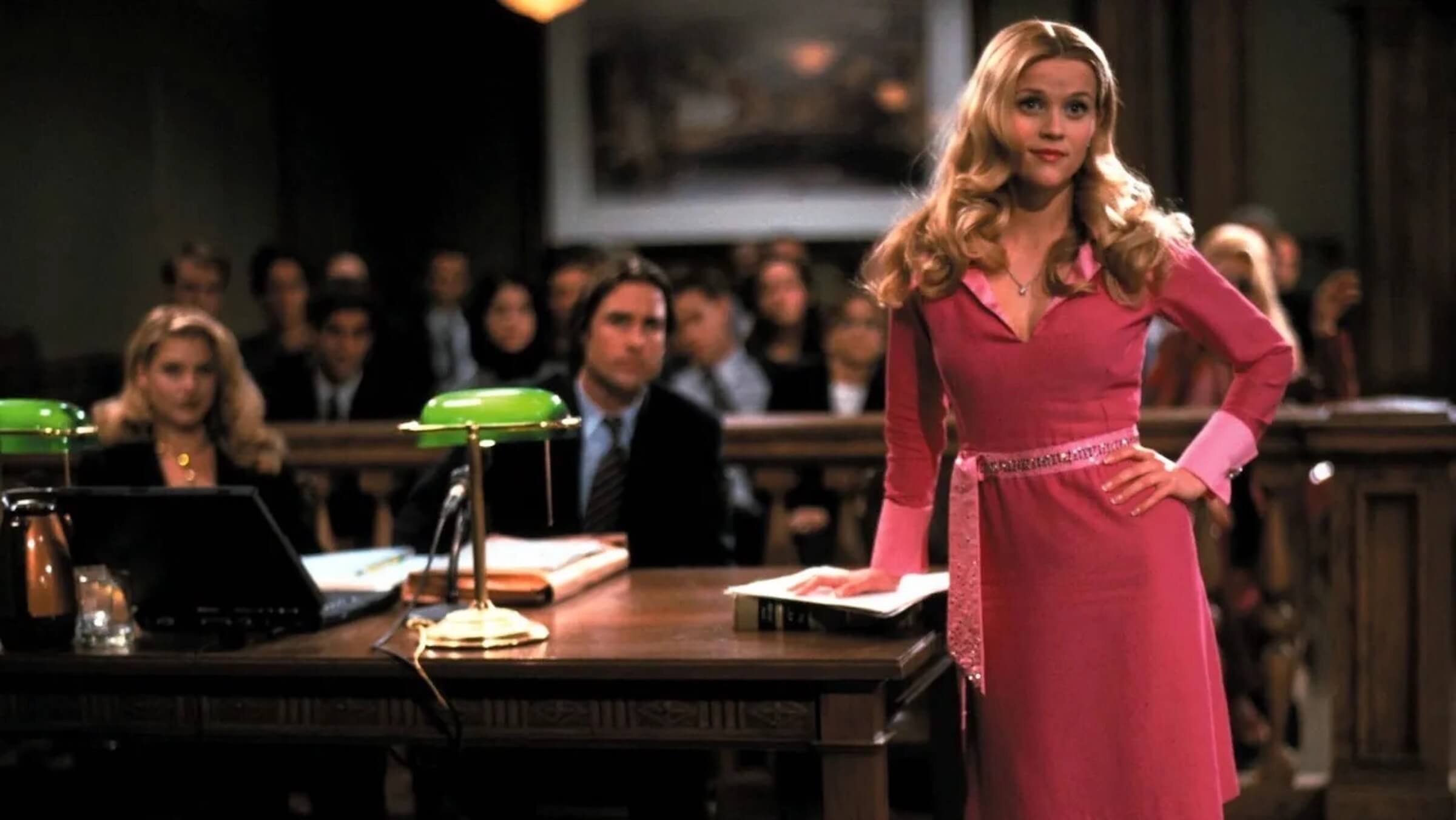 Elle Woods (Reese Witherspoon) in a pink dress in a courtroom in 'Legally Blonde,' The Verdict Is In: These Are Courtroom Scripts You Have to Read