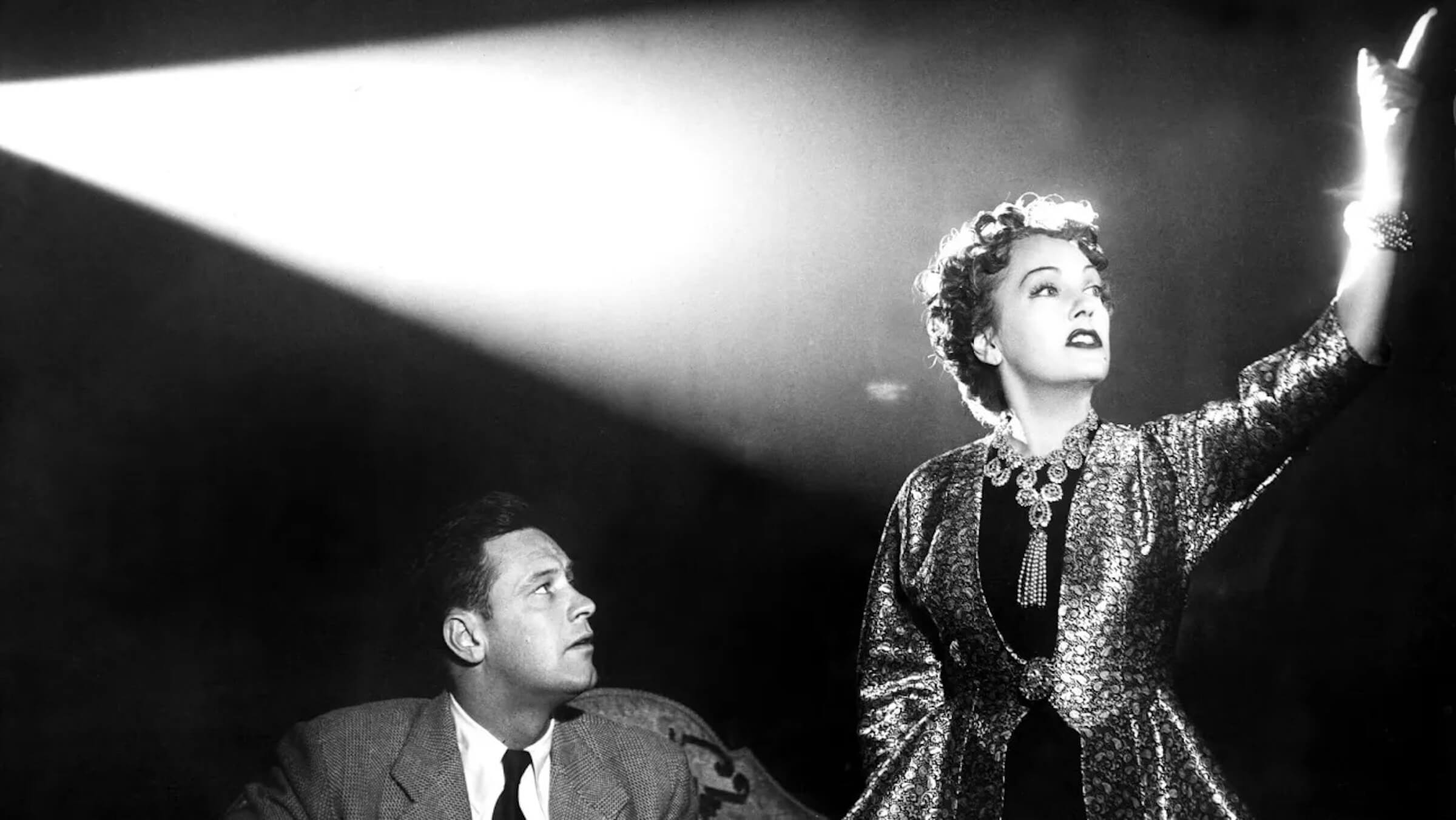 Norma Desmond (Gloria Swanson) standing in the light of the projector in 'Sunset Boulevard;' A Brief History of Film Noir