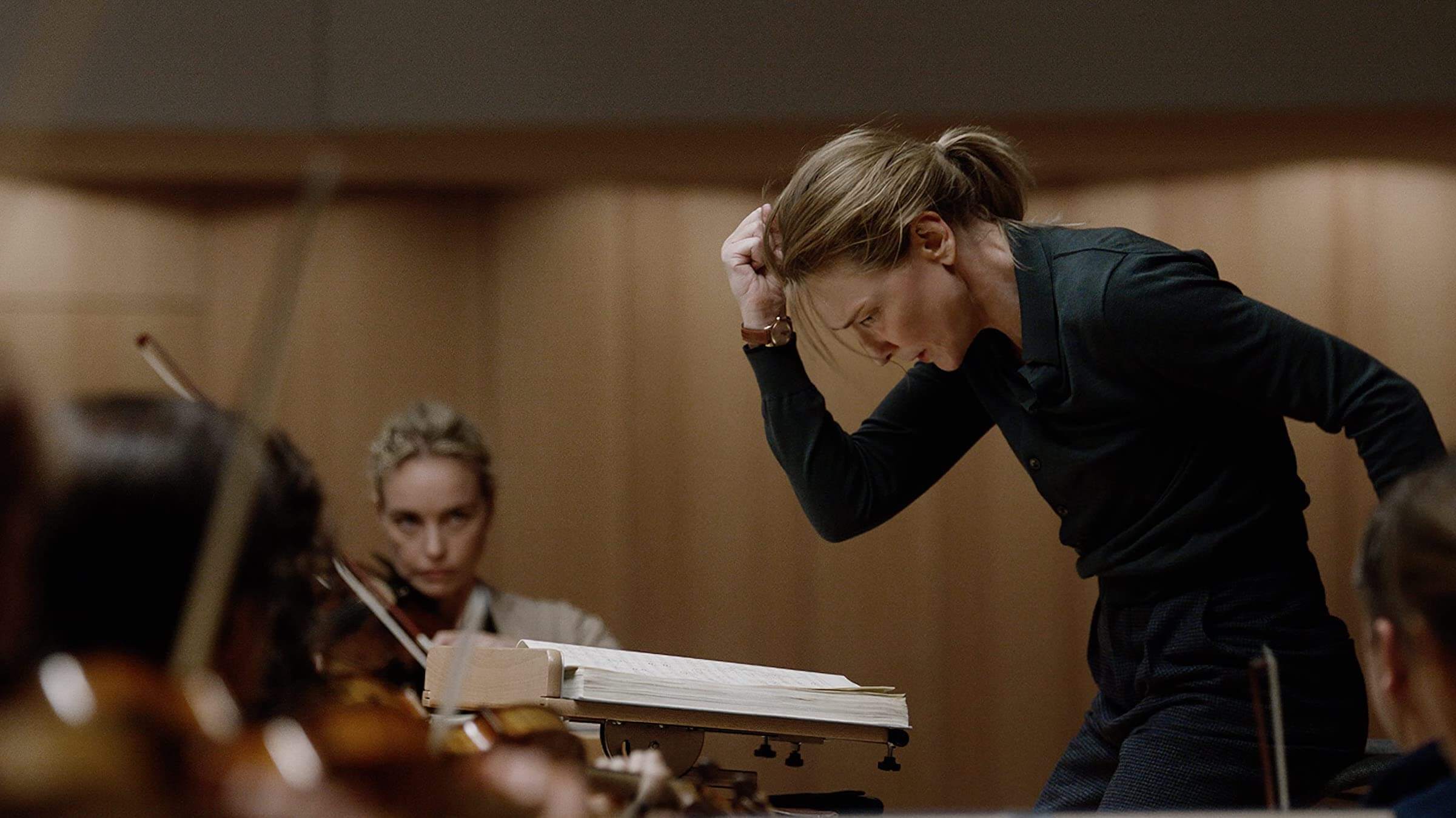 Lydia Tar (Cate Blanchett) conducting during orchestra practice in 'Tar,' Sonic Stories: The Cinematic Magic of Movies About Music