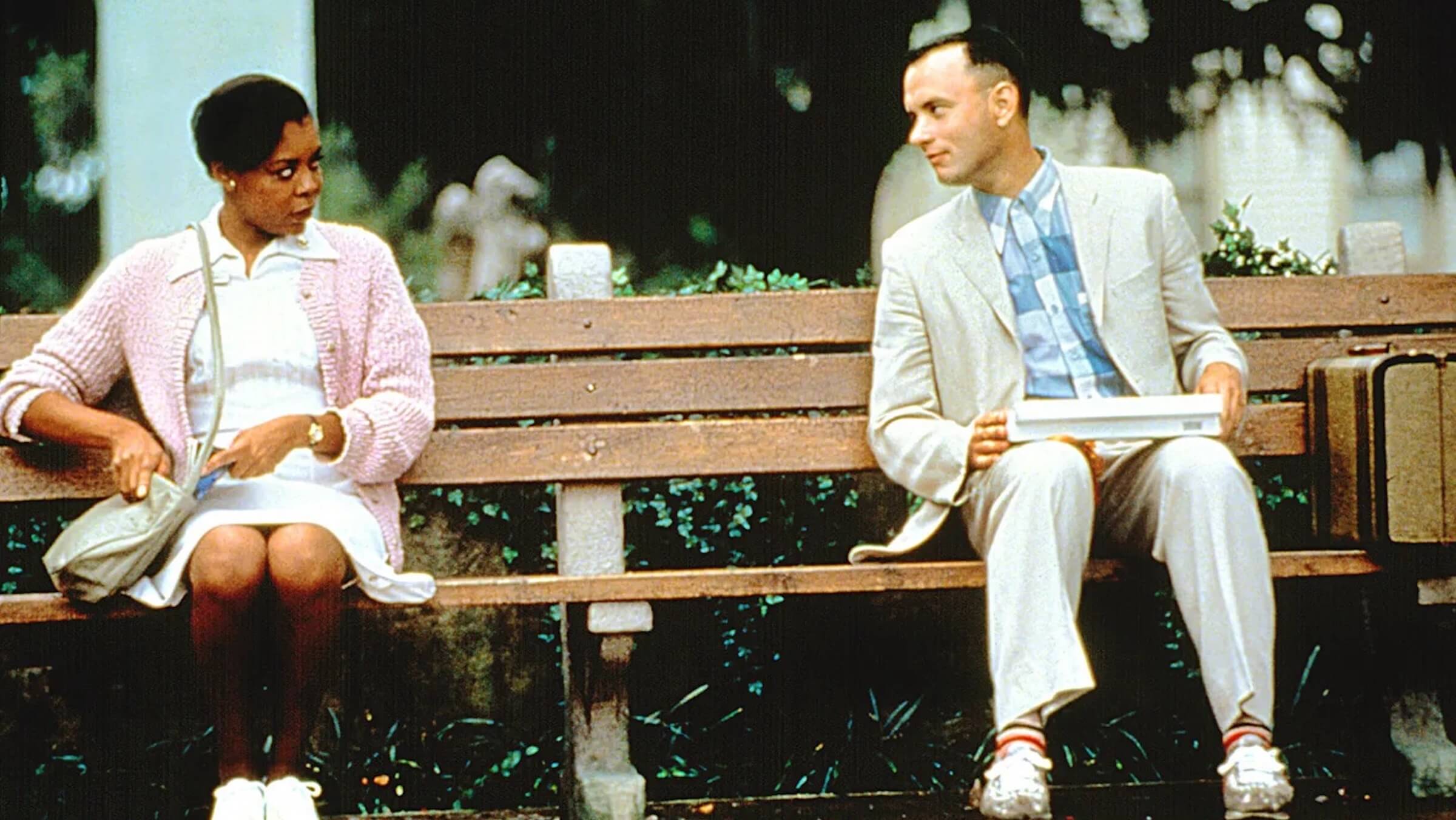 Forrest Gump (Tom Hanks) sitting on a bus bench with a box of chocolates in 'Forrest Gump,' 15 Most Quotable Movies of All Time