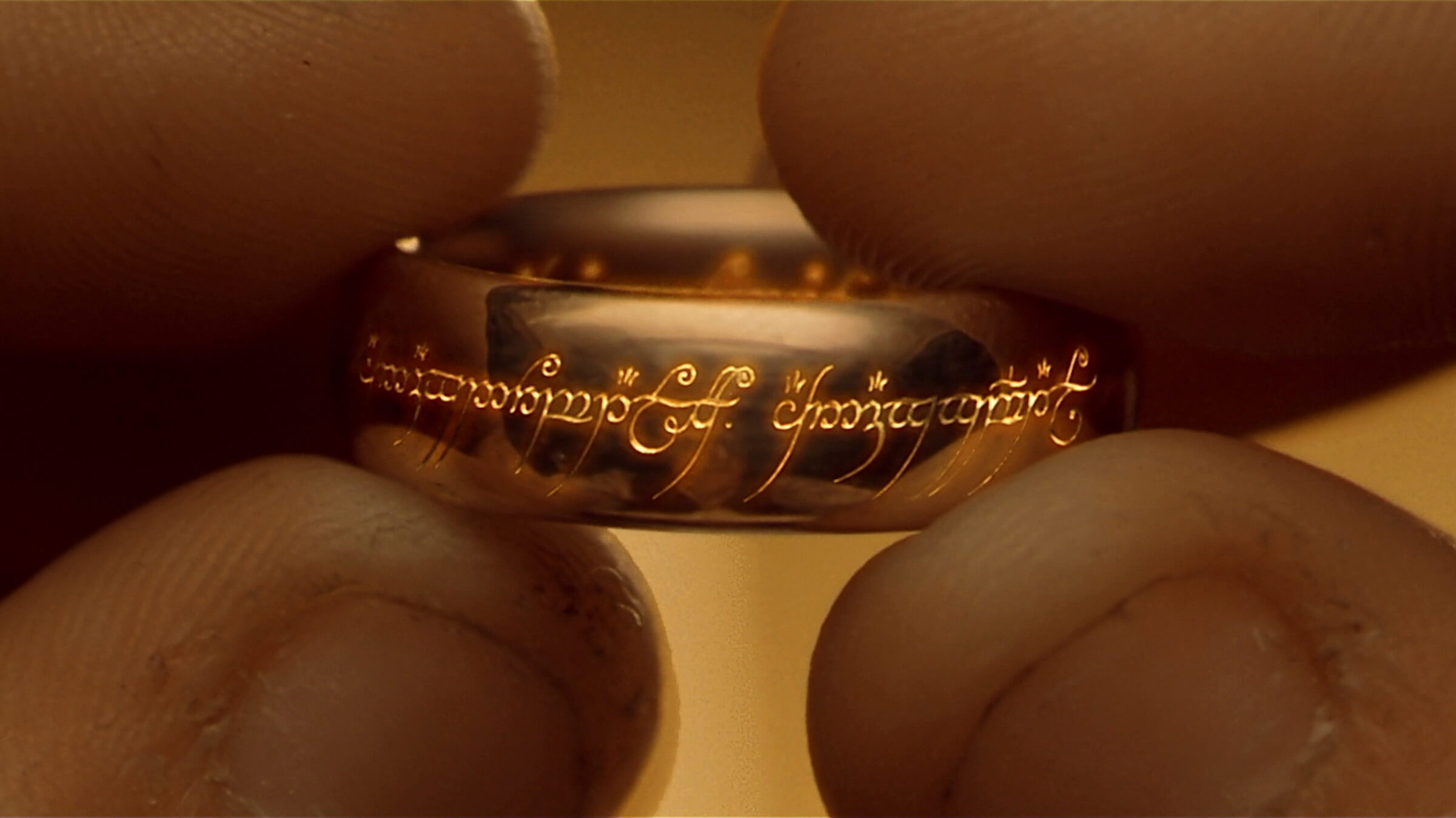 A close up of fingers holding the One Ring in ''The Lord of the Rings: The Fellowship of the Ring'