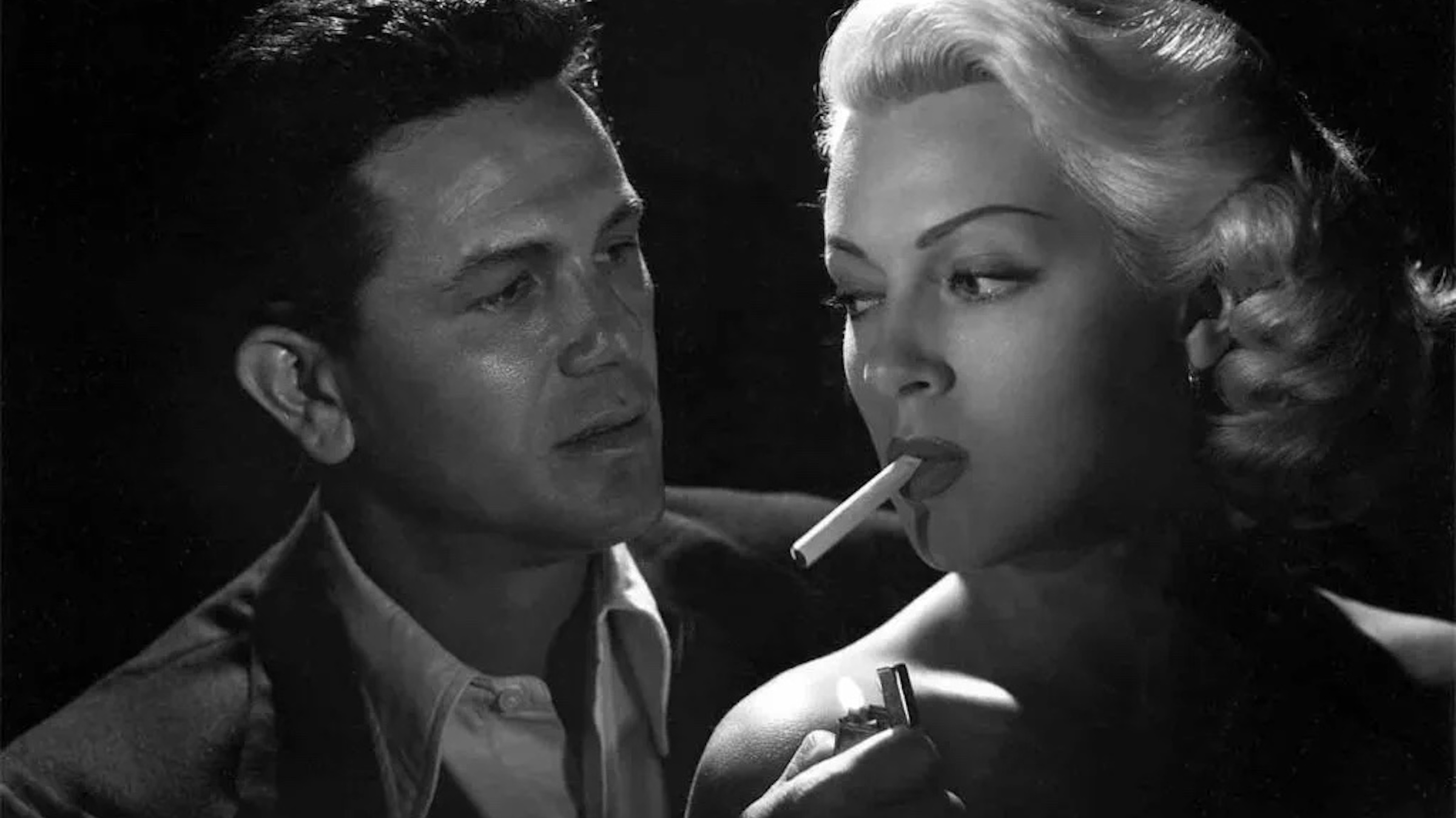 Cora Smith (Lana Turner) having a cigarette lit by Frank (John Garfield) in 'The Postman Always Rings Twice,' 10 of the Most Dangerous Femme Fatales in Cinema