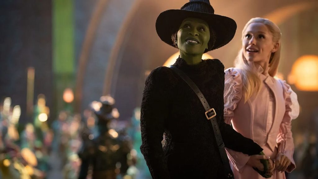 Elphaba (Cynthia Erivo) and Glinda (Ariana Grande) walking through the Emerald City in 'Wicked.'